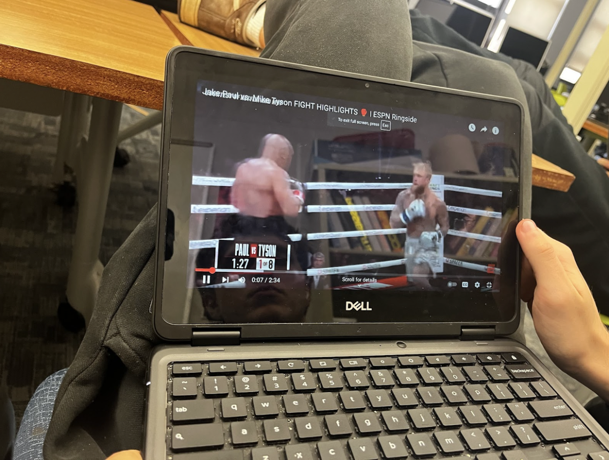 Nathan Wietecha, senior, watches the Jake Paul vs Mike Tyson fight on his Chromebook.
